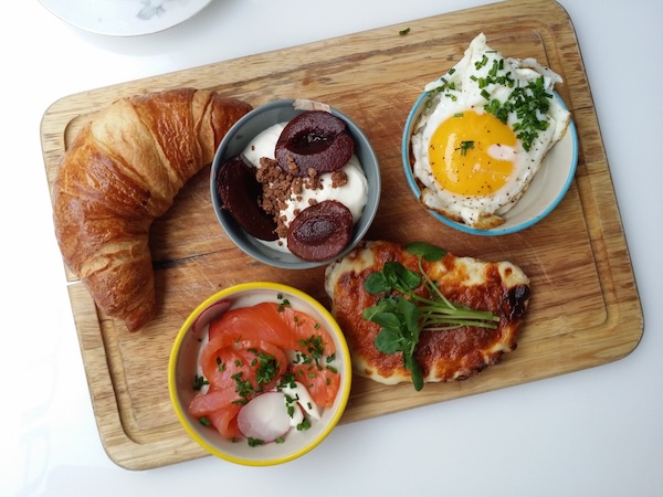 A breakfast tray featuring a croissant